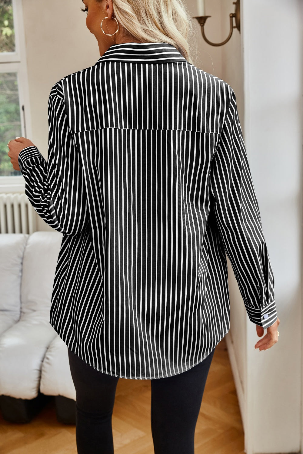 Black and white striped collared shirt unbuttoned